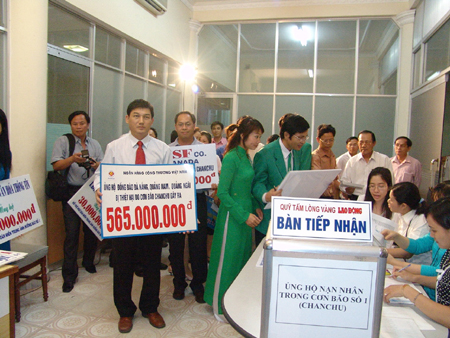 Ông Phạm Huy Hùng - Chủ tịch HĐQT Ngân hàng TMCP Công thương Việt Nam (Vietinbank) - trao tiền của cán bộ, nhân viên Vietinbank hỗ trợ cho ngư dân miền Trung bị thiệt hại trong bão Chanchu. Ảnh: N.T.H