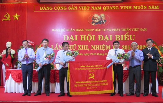 Đồng chí Nguyễn Quang Dương - Phó Bí thư Thường trực Đảng ủy Khối trao tặng Cờ của Đảng ủy Khối DNTW cho Đảng bộ BIDV