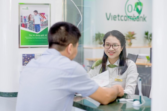 Cán bộ Vietcombank tư vấn về sản phẩm và hướng dẫn khách hàng các thủ tục trong giao dịch.