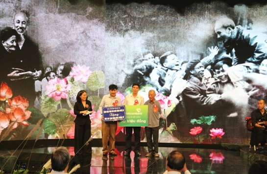 Đại diện Đảng ủy Ngân hàng TMCP Ngoại thương Việt Nam trao sổ tiết kiệm 50 triệu đồng cho gia đình có hoàn cảnh khó khăn.