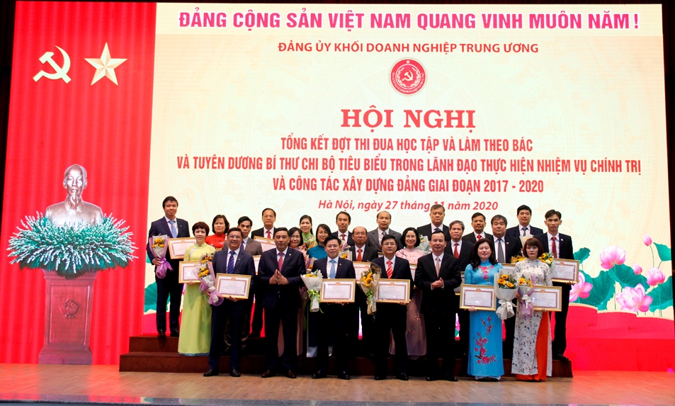 Đồng chí Nguyễn Lam, Phó Trưởng Ban Dân vận Trung ương và đồng chí Hoàng Giang, Phó Bí thư Đảng ủy Khối trao Bằng khen và tặng hoa chúc mừng các đồng chí bí thư chi bộ tiêu biểu.
