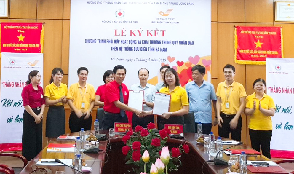 Chị Hường đại diện Bưu điện tỉnh ký chương trình phối hợp với Hội Chữ thập đỏ tỉnh Hà Nam